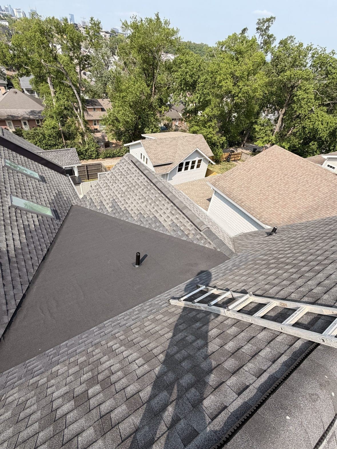 Fresh roof and flat-roof section on a 12 South home with the Nashville skyline beyond